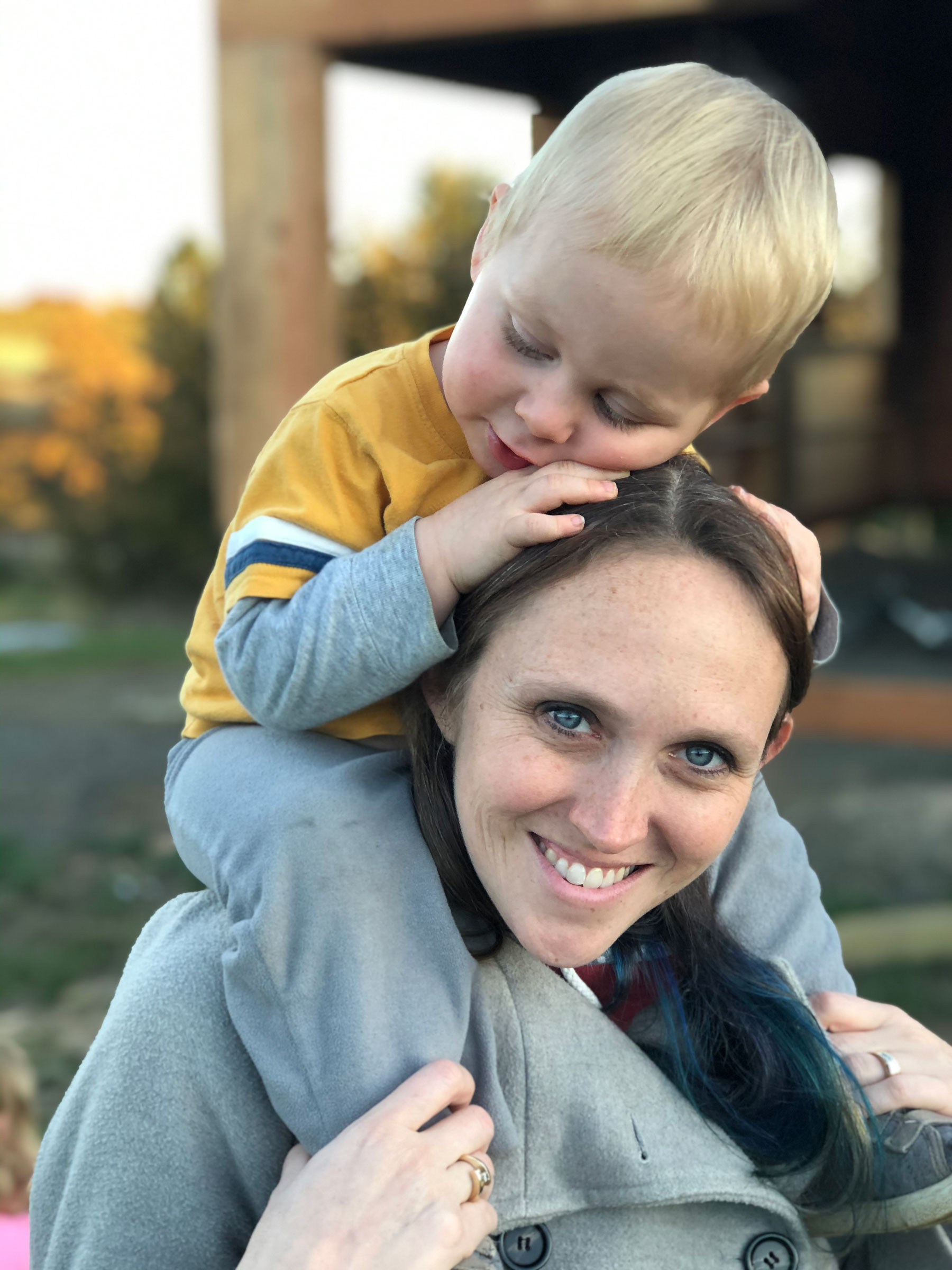 Kim Bellingar with her son on her shoulders