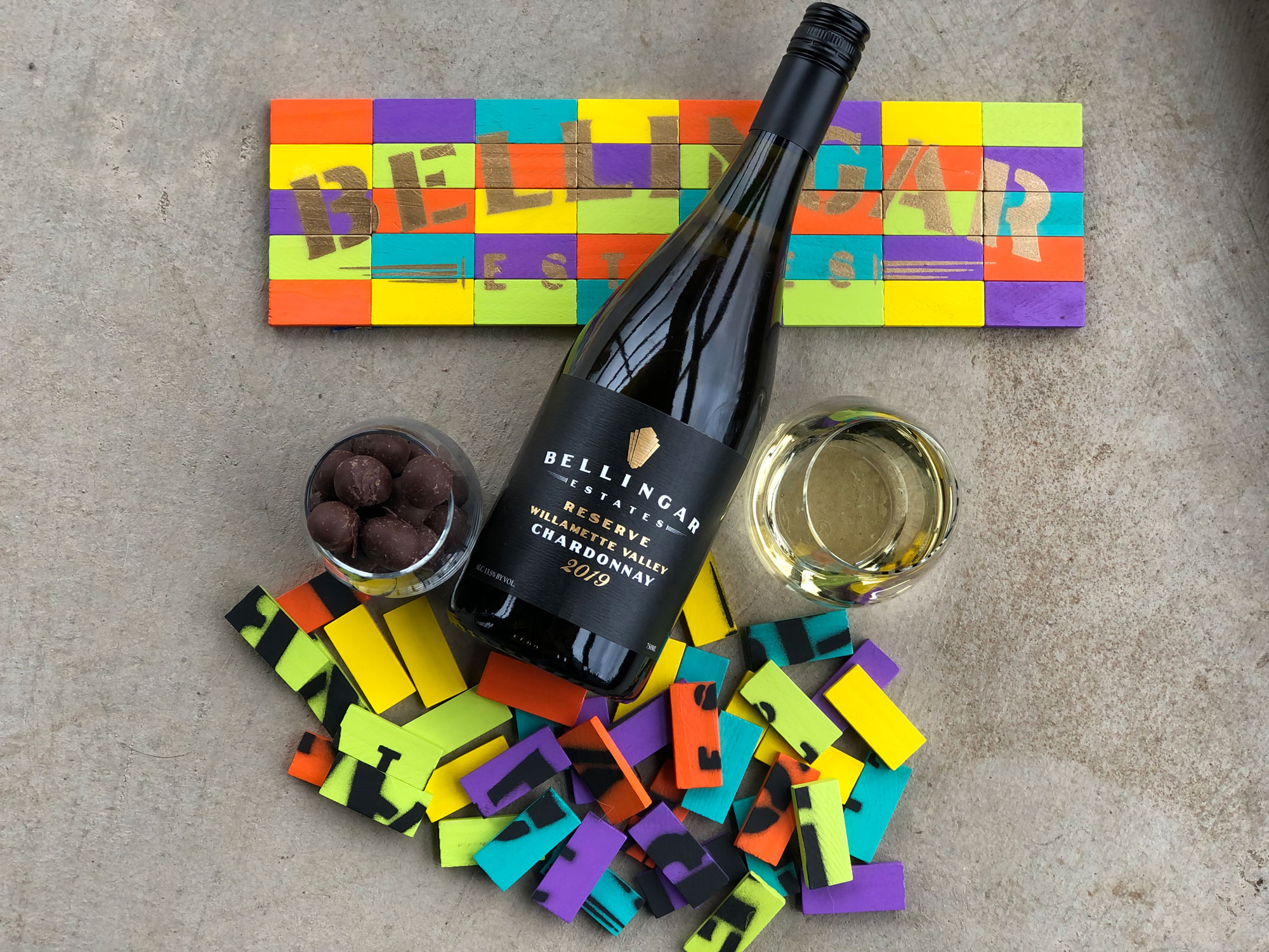 A bottle of Bellingar Estates wine with a colorful sign