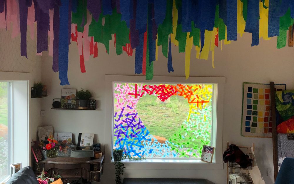 Colorful streamers hanging down from the ceiling in a living room